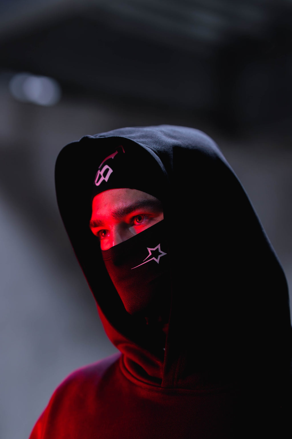 Synced All Season Balaclava styled with hoodie in red lighting